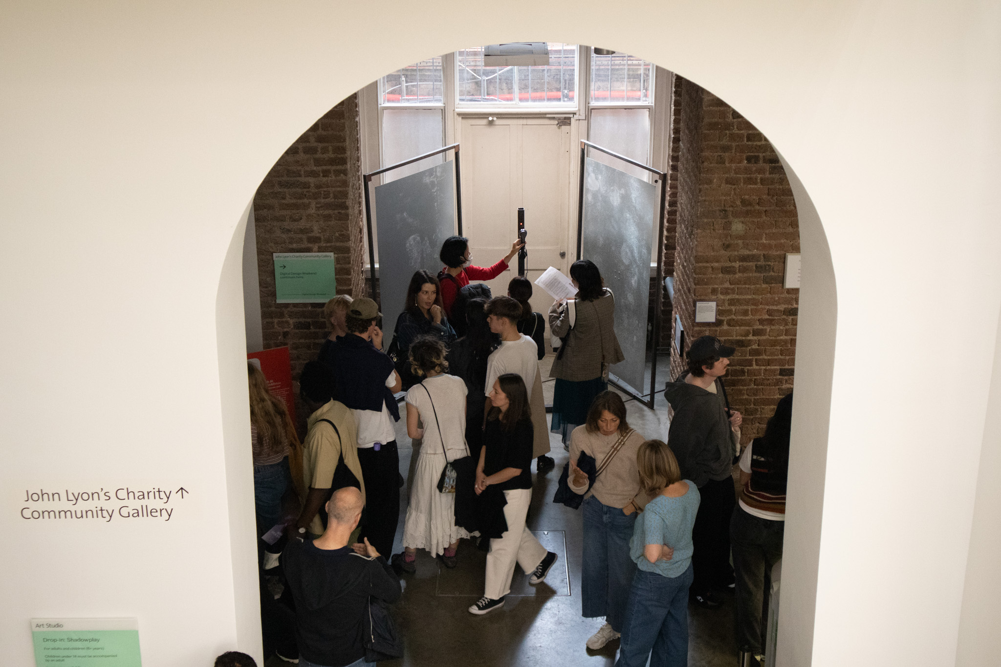 Phone on a metal pole with a red light ontop of it